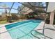 Screened pool area with clear blue pool, playset, and grill at 7410 Locksley Ln, Lakeland, FL 33809