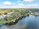 Overhead shot showcasing a lakefront property with a private dock, surrounded by lush greenery and serene water at 794 Lake Clark Ct, Lakeland, FL 33813