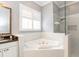 Modern bathroom featuring a soaking tub and a glass shower at 794 Lake Clark Ct, Lakeland, FL 33813