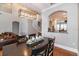 Dining room with a dark wood table, pendant lighting, and an archway into kitchen at 794 Lake Clark Ct, Lakeland, FL 33813