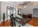 Bright and spacious dining room featuring an elegant chandelier, hardwood floors, and an open floor plan at 794 Lake Clark Ct, Lakeland, FL 33813