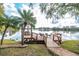 Scenic lakeside dock featuring seating, a swing, and easy access to the water, ideal for relaxation and waterfront enjoyment at 794 Lake Clark Ct, Lakeland, FL 33813