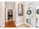 Welcoming foyer with tile flooring, a decorative mirror niche, and a view of the laundry room at 794 Lake Clark Ct, Lakeland, FL 33813