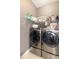 Convenient laundry room features modern front load washer and dryer with storage at 794 Lake Clark Ct, Lakeland, FL 33813