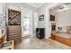 Bright sitting room with a fireplace, travertine floors, and a wine cabinet at 794 Lake Clark Ct, Lakeland, FL 33813