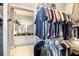 Organized walk-in closet features rods, shelving, and a glimpse of a double vanity in an adjacent bathroom at 794 Lake Clark Ct, Lakeland, FL 33813