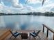 Dock with chairs overlooking peaceful lake at 794 Lake Clark Ct, Lakeland, FL 33813