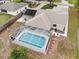 Aerial view of the property featuring a screened pool and well-maintained landscaping at 7965 Kaitlin Cir, Lakeland, FL 33810