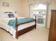 Comfortable bedroom featuring natural light, a classic bed, and an airy ambiance at 7965 Kaitlin Cir, Lakeland, FL 33810