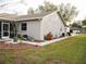 Exterior view of the house featuring the side yard, landscaped with various decorative plants at 7965 Kaitlin Cir, Lakeland, FL 33810