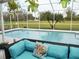 Inviting screened pool area featuring a comfortable seating area and lush greenery at 7965 Kaitlin Cir, Lakeland, FL 33810