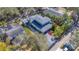 Aerial view displays a home with a backyard, detached garage, and lush landscaping, offering privacy at 815 Success Ave, Lakeland, FL 33801