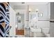 Classic bathroom features white tile, vintage sink, and a view of the staircase at 815 Success Ave, Lakeland, FL 33801