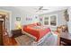 Sunny bedroom featuring a large bed, hardwood floors, and natural light at 815 Success Ave, Lakeland, FL 33801