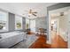 Bedroom with wood floors, ceiling fan, windows and views into the hallway at 815 Success Ave, Lakeland, FL 33801