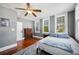 Cozy bedroom features hardwood floors, ceiling fan, and plenty of natural light from three windows at 815 Success Ave, Lakeland, FL 33801