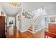 Entryway with wood floors, staircase, and artfully arranged Gathering photos on the wall at 815 Success Ave, Lakeland, FL 33801