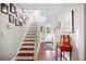 Bright entryway with wood floors, staircase, and stylish decorations on the wall at 815 Success Ave, Lakeland, FL 33801