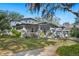 Beautiful front exterior showcasing the home's architectural details, spacious porch, and mature trees at 815 Success Ave, Lakeland, FL 33801