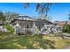 Exterior shot shows a Craftsman home with a welcoming front porch, pillars and landscaped yard at 815 Success Ave, Lakeland, FL 33801