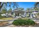 Charming front exterior featuring a covered porch, well-manicured lawn and inviting curb appeal at 815 Success Ave, Lakeland, FL 33801