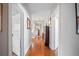 Hallway featuring gleaming wood floors, a chandelier, and doorways leading to other rooms at 815 Success Ave, Lakeland, FL 33801