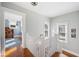 Upstairs hallway with wood floors, windows, and a view into the room at 815 Success Ave, Lakeland, FL 33801