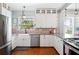 Bright kitchen with white cabinets, stainless steel appliances, and a large farmhouse sink at 815 Success Ave, Lakeland, FL 33801