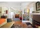 Bright living room featuring hardwood floors, brick fireplace, piano, and coffered ceilings at 815 Success Ave, Lakeland, FL 33801