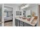 Bright bathroom with a large vanity, framed mirror, and decorative accessories at 8185 Woodvine Cir, Lakeland, FL 33810