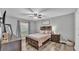 Cozy bedroom featuring wood floors, soft lighting, and a decorative headboard at 8185 Woodvine Cir, Lakeland, FL 33810