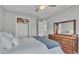 This bedroom features a queen bed, a dresser, and a ceiling fan for added comfort at 8185 Woodvine Cir, Lakeland, FL 33810