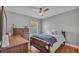 This stylish bedroom features a queen bed, a dresser, and a ceiling fan for added comfort at 8185 Woodvine Cir, Lakeland, FL 33810