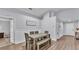 Bright dining area featuring a wooden table with bench seating, hardwood floors, and neutral-colored walls at 8185 Woodvine Cir, Lakeland, FL 33810