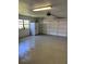 Clean garage with a fridge and plenty of space for parking and storage at 838 Lakeshore Dr, Polk City, FL 33868