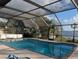 Refreshing screened-in pool area with a view of the lake at 838 Lakeshore Dr, Polk City, FL 33868