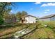 View of the home's backyard, featuring a new patio and ample green space for outdoor activities at 118 W Northside Dr, Lake Wales, FL 33853