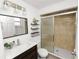 This bathroom features wood cabinets and a glass shower at 118 W Northside Dr, Lake Wales, FL 33853