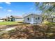 Well-maintained home featuring manicured garden beds, a light gray exterior, and well-kept lawn at 118 W Northside Dr, Lake Wales, FL 33853