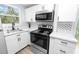 Bright kitchen featuring stainless steel appliances, marble countertops, and a decorative backsplash at 118 W Northside Dr, Lake Wales, FL 33853