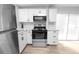 Updated kitchen featuring stainless steel appliances, white cabinets, and a decorative backsplash at 118 W Northside Dr, Lake Wales, FL 33853