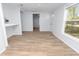 Bright living room featuring wood-look flooring, lots of light, and an open floor plan at 118 W Northside Dr, Lake Wales, FL 33853