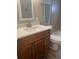 Bathroom featuring a single vanity with white countertop, wood-look flooring, and a framed mirror at 14 Buck Cir # 14, Haines City, FL 33844