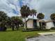 Condo building with tropical landscaping, including tall palm trees at 14 Buck Cir # 14, Haines City, FL 33844