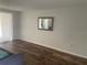 Bright living room featuring wood-look floors, a neutral color scheme, and a decorative wall mirror at 14 Buck Cir # 14, Haines City, FL 33844