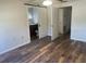 Light-filled main bedroom featuring wood floors, a ceiling fan, and an ensuite bathroom at 14 Buck Cir # 14, Haines City, FL 33844