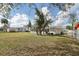 Residential home backyard featuring ample green space and privacy at 144 Lowell Rd, Winter Haven, FL 33884