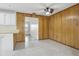 Cozy dining area with wood-paneled walls and view to the kitchen and living areas at 144 Lowell Rd, Winter Haven, FL 33884