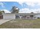 Inviting single-story home with a classic design and a well-manicured front yard at 144 Lowell Rd, Winter Haven, FL 33884