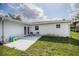 Backyard patio area with a pair of chairs and an exterior view of the home at 144 Mirror Nw Ln, Winter Haven, FL 33881